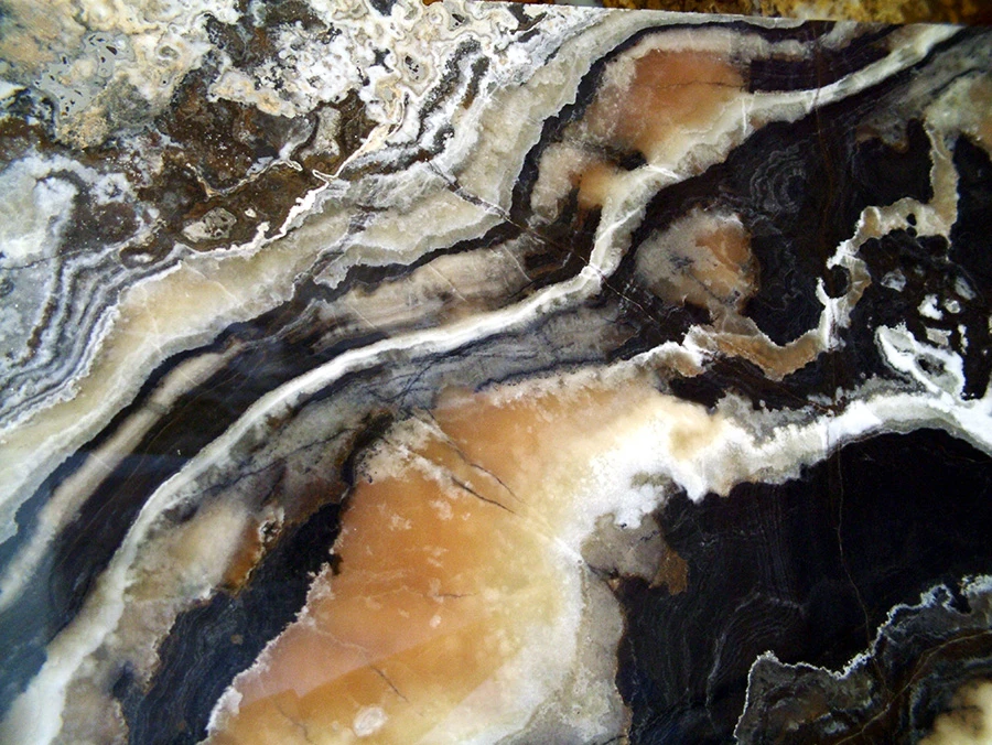 Black Canyon Onyx with black, gray and white bands around amber-colored areas.