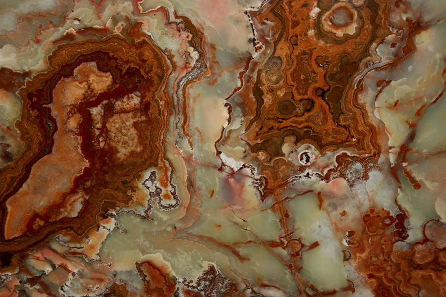 Grand Canyon Onyx with rust-red and brown bands around pale green and cream areas.