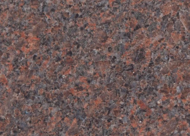 Dakota Mahogany Select granite surface showing brown, blue-grey and dark mineral grains.