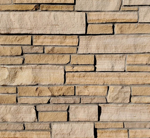 Aspen Buff sandstone ledge veneer in warm buff and tan courses.