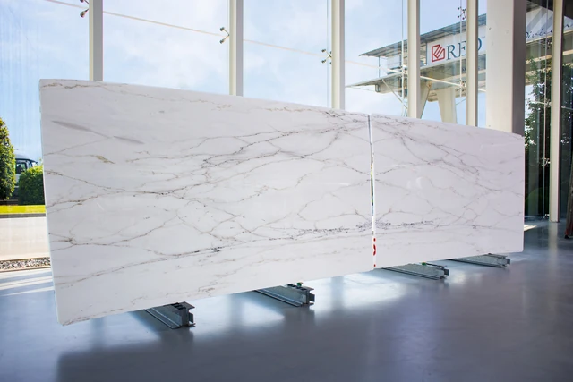 Calacatta Golden marble slabs shown in the producer gallery.