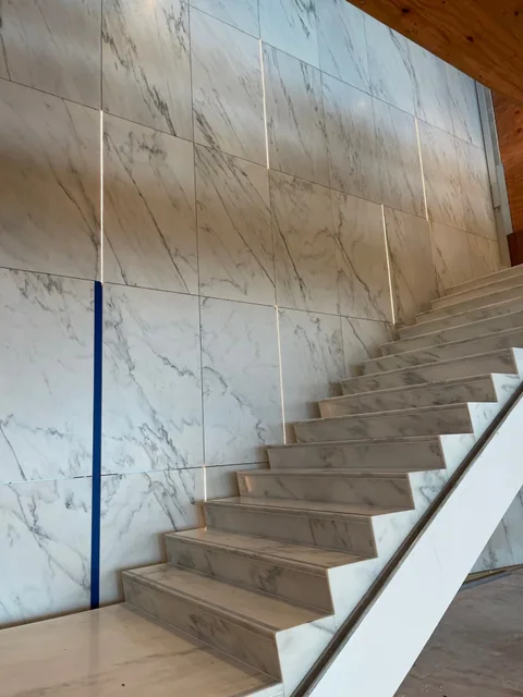 Installed Crème Extra wall panels and stair at FIS Headquarters.