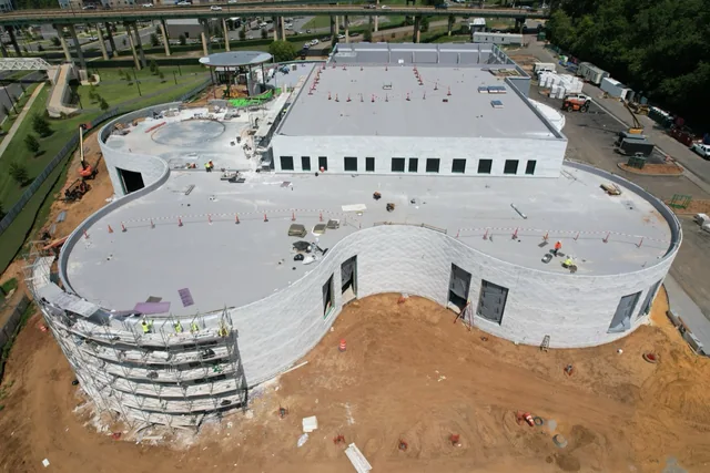 Aerial construction view of curved Alabama White marble elevations at the Saban Center.