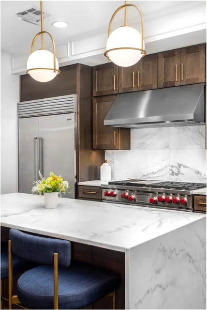 Crème Extra marble waterfall island, countertops and backsplash in a Broadwest residence kitchen.