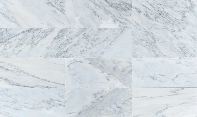 An arrangement of Alabama Scuro marble pieces with varied directional gray movement.