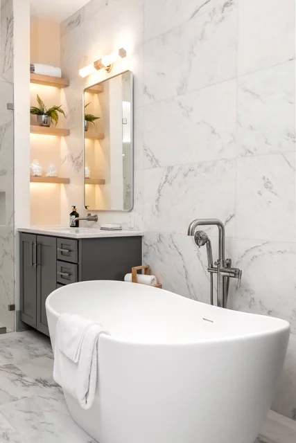 A residential bath with Crème Extra marble wall surfaces and vanity.